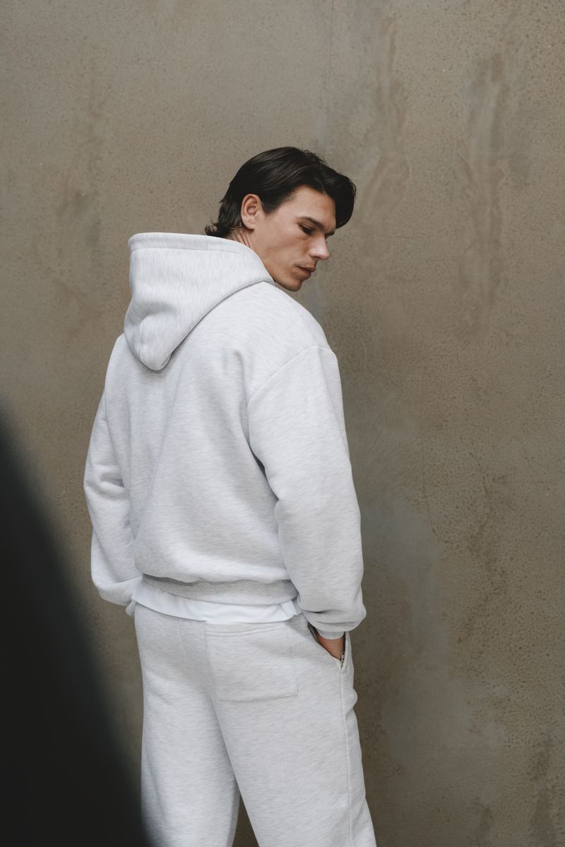 A relaxed portrait against the studio's plaster wall.